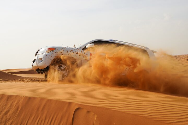 Experience the thrill of the desert as you cruise through golden sands in an SUV capturing unforgettable moments on your Dubai adventure. A true highlight awaits!